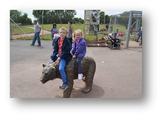 Adam and Emily riding a bronze cast of a bear. No bears were harmed in the making of this photograph