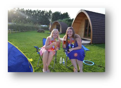 Rachel and her friend Susanne enjoying a cheeky vino in the sunshine on a glamping trip with the kids over the summer hols
