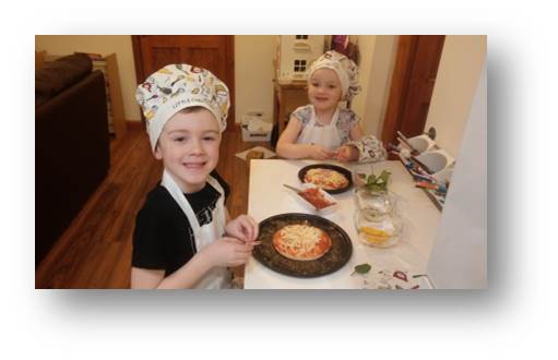 Adam and Emily trying their hand at making their own pizzas