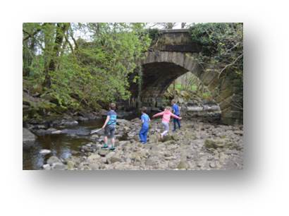 Skimming stones into Keasden Beck with the Traynor's