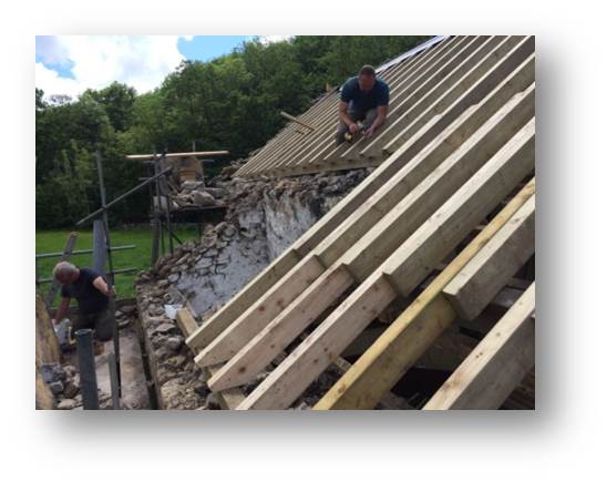 Making our way across the roof securing timbers as we go