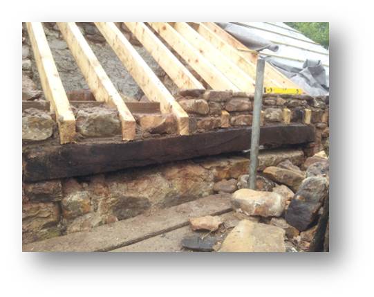 We have installed new concrete lintels over what will be the outdoor seating area however, re-using the old oak purlins as a non-load bearing feature helps retain the look of the old building.