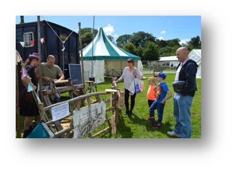 The in-laws look on as I learn some traditional skills and make my own one legged stool on a traditional foot-operated oak lathe