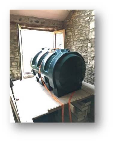 The foul water tank in the building, but not yet in position in the cellar