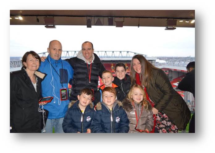 Family photo of Gary at Anfield Stadium L-R with Margaret, Gary, Rob, Hugo, Adam, Oscar, Oliver, Emily and Rachel