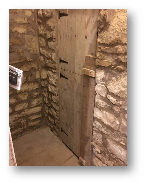 image of a rear barn-door constructed with reclaimed floorboards