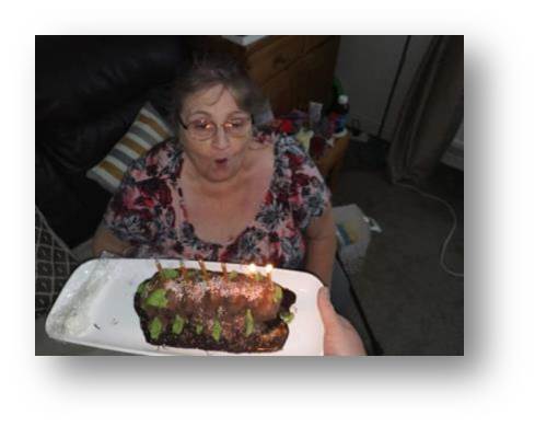 Mum taking a go at getting those candles blown out