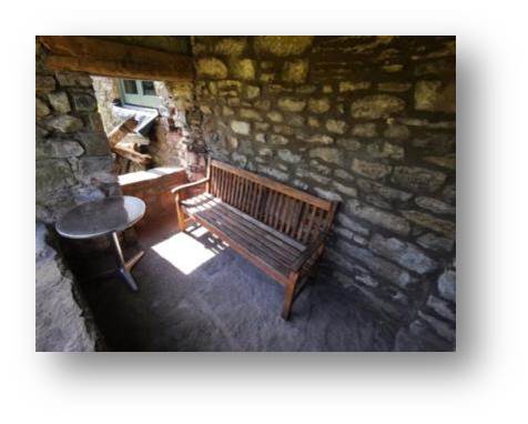 The cleaned-up bench in its resting place around the back of the hall in the seating area